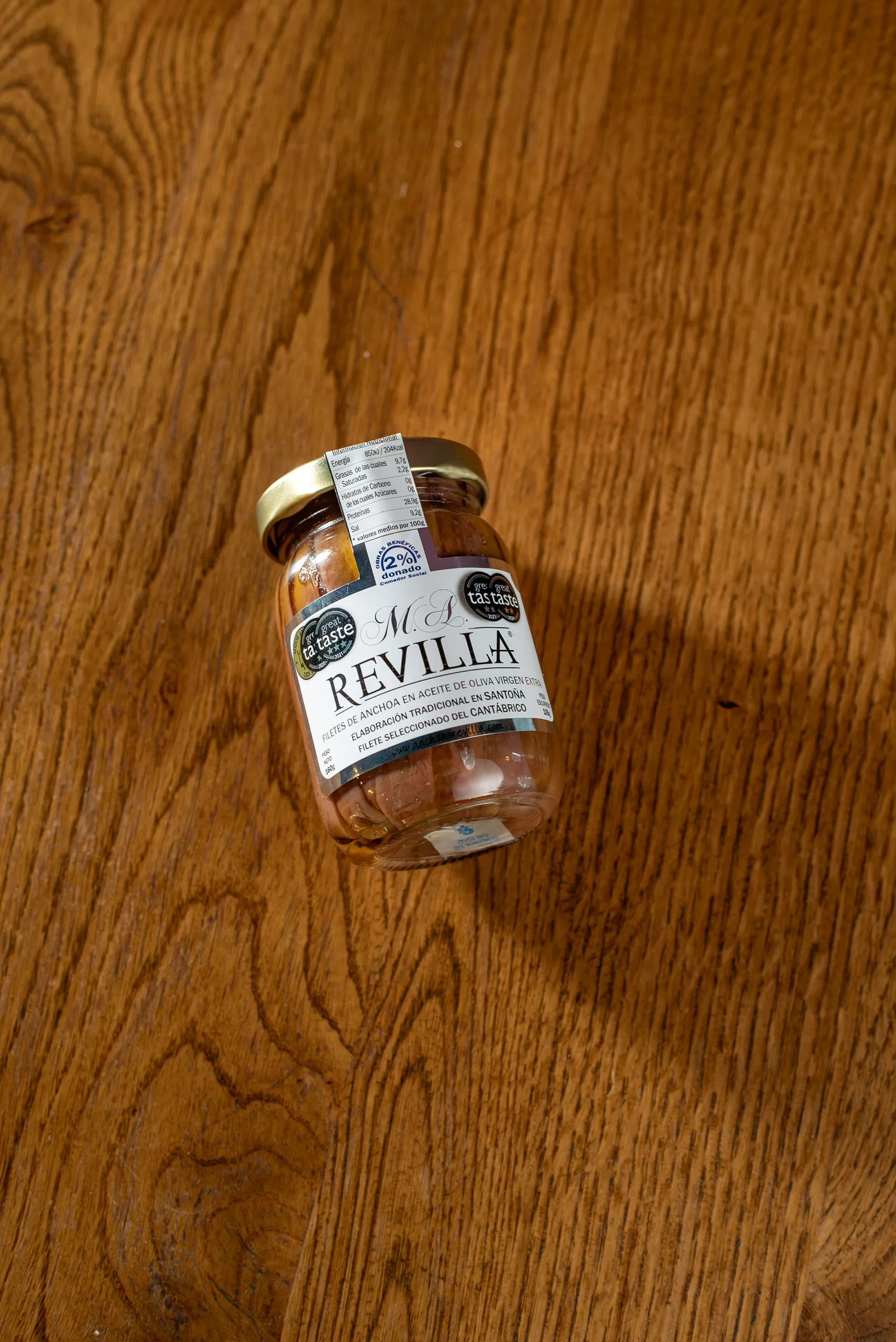 Glass jar of M.A. Revilla Cantabrian anchovy fillets in extra virgin olive oil.